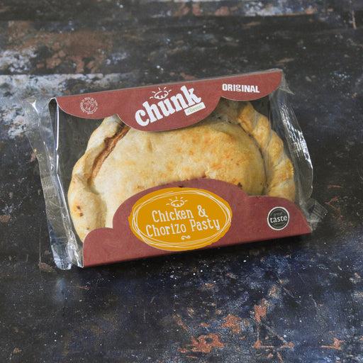 A packaged baked pasty in a clear plastic clamshell with a branded cardboard insert. The insert reads 'chunk Original' and 'Chicken & Chorizo Pasty,' and the pasty itself is golden brown inside.