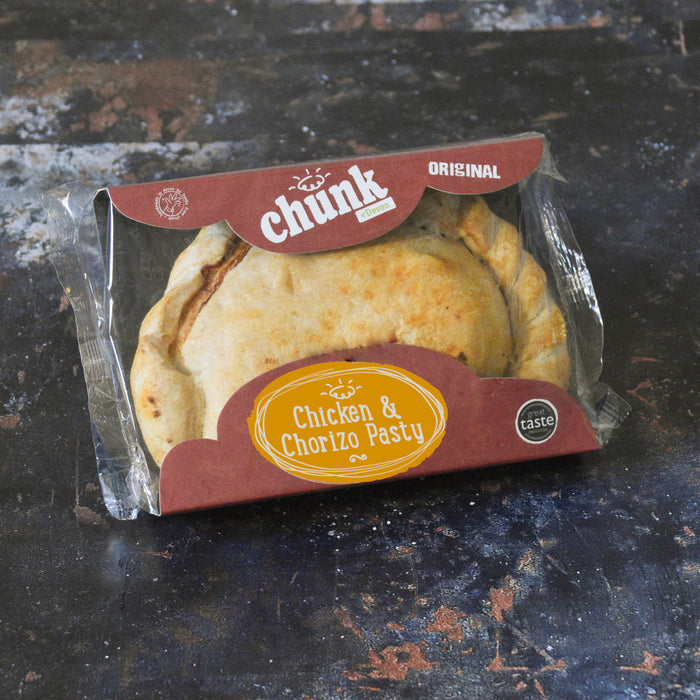 A packaged baked pasty in a clear plastic clamshell with a branded cardboard insert. The insert reads 'chunk Original' and 'Chicken & Chorizo Pasty,' and the pasty itself is golden brown inside.