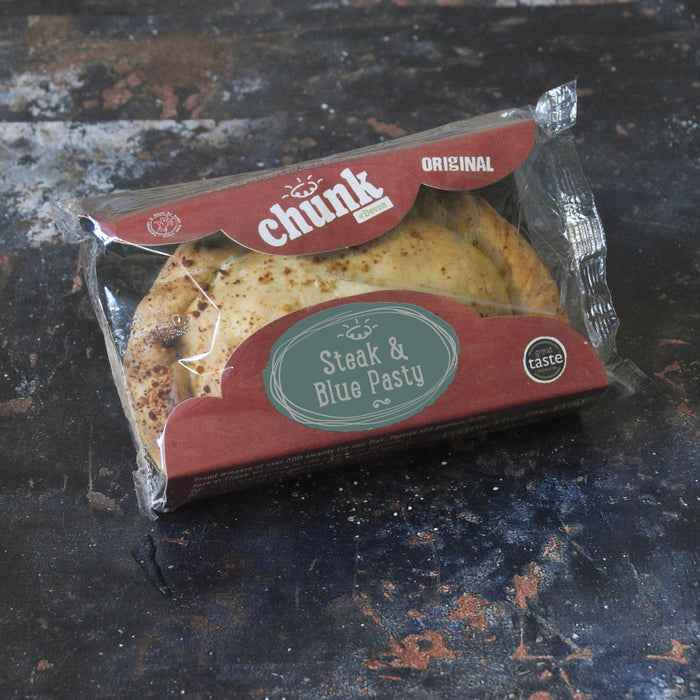 Chunk original Steak and blue cheese pasty wrapped on a rustic background