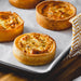 Handmade gluten-free quiche baked in Devon, featuring a golden pastry case and savoury filling.
